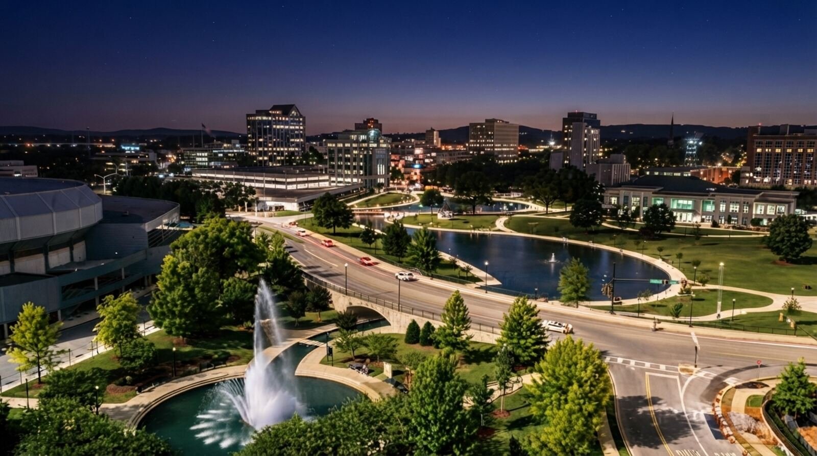 Big Spring International Park and downtown Huntsville, Alabama at dusk, with the fountain lit and the Von Braun Center at left